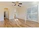 Bright bedroom with hardwood flooring, modern fan, and sliding shutter closet doors at 4739 Silverking Way, Palm Harbor, FL 34684
