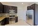 Well-equipped kitchen boasts stainless steel appliances, granite countertops, tile backsplash, and ample storage at 4739 Silverking Way, Palm Harbor, FL 34684