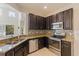 Modern kitchen featuring stainless steel appliances, granite countertops, and ample cabinet space at 4739 Silverking Way, Palm Harbor, FL 34684