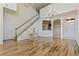 Bright and airy living room showcasing hardwood floors, a staircase, and an open layout at 4739 Silverking Way, Palm Harbor, FL 34684