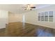 Living room featuring hardwood floors, neutral walls, ceiling fan and plantation shutters at 4739 Silverking Way, Palm Harbor, FL 34684