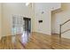 Open-concept living room with hardwood floors, abundant natural light, and a sliding glass door leading to a patio at 4739 Silverking Way, Palm Harbor, FL 34684