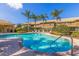 Beautiful community pool area with inviting lounge chairs and lush landscaping on a sunny day at 4739 Silverking Way, Palm Harbor, FL 34684