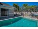 Clear swimming pool with stone pavers, privacy wall and lush, tropical landscaping at 8155 Elisabeth Ln, Seminole, FL 33777