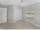 Minimalist bedroom featuring tiled floors, a double door closet, and neutral wall color at 8941 Southbay Dr, Tampa, FL 33615