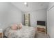 Comfortable bedroom featuring a cozy bed, side table, and ample natural light at 8941 Southbay Dr, Tampa, FL 33615