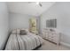 Bright bedroom with tile floors, featuring a comfortable bed, and a dresser at 8941 Southbay Dr, Tampa, FL 33615