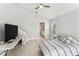 Neutral bedroom with sleek floors, featuring a comfortable bed, television, and ensuite bathroom at 8941 Southbay Dr, Tampa, FL 33615