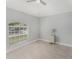 Cozy bedroom featuring tiled floors, a large window, and neutral wall color at 8941 Southbay Dr, Tampa, FL 33615