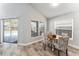 Charming breakfast nook with a round table, patterned chairs, and views of the pool area through large windows at 8941 Southbay Dr, Tampa, FL 33615