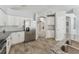 Modern kitchen featuring white cabinets, stainless steel appliances, granite countertops, and wood look ceramic tile floors at 8941 Southbay Dr, Tampa, FL 33615