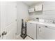 Clean laundry room with washer, dryer, and shelving for ample storage space at 8941 Southbay Dr, Tampa, FL 33615