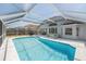 Relaxing screened-in pool area with clear blue water, poolside furniture, and covered enclosure at 8941 Southbay Dr, Tampa, FL 33615