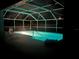 Inviting screened-in pool shimmers with cool blue light at 8941 Southbay Dr, Tampa, FL 33615