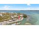 Aerial view of waterfront home on a beautiful day, surrounded by lush landscapes and blue waters at 9696 Little Gasparilla Isand, Placida, FL 33946