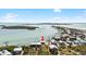Aerial view of waterfront property with private dock and boat lift at 9696 Little Gasparilla Isand, Placida, FL 33946