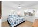 Bright bedroom features a ceiling fan, two windows, and beach-themed bedding at 9696 Little Gasparilla Isand, Placida, FL 33946