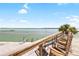 Water view from exterior deck with chairs and landscaping at 9696 Little Gasparilla Isand, Placida, FL 33946