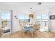 Cozy dining area with glass table, seating for six, water views, and access to the deck at 9696 Little Gasparilla Isand, Placida, FL 33946