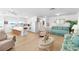 Open-concept living area featuring a kitchen, dining space, and comfortable seating with water views at 9696 Little Gasparilla Isand, Placida, FL 33946