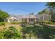 Expansive backyard view showing the screened-in pool and mature landscaping at 14472 Linden Dr, Spring Hill, FL 34609