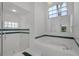 Clean bathroom with a glass-enclosed shower, a jacuzzi tub, and a large mirror at 14472 Linden Dr, Spring Hill, FL 34609