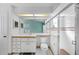 Bright bathroom featuring a sink with vanity, a toilet, and a glass-enclosed shower with white tiles at 14472 Linden Dr, Spring Hill, FL 34609