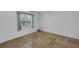Simple bedroom with travertine floors, plantation shutters and a ceiling fan at 14472 Linden Dr, Spring Hill, FL 34609