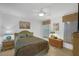 Bedroom with ceiling fan, neutral walls, and a queen-size bed with side tables and lamps at 14472 Linden Dr, Spring Hill, FL 34609