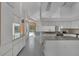 Modern kitchen with white cabinets, gray countertops, and stainless steel appliances at 14472 Linden Dr, Spring Hill, FL 34609