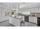 Spacious kitchen with white cabinets, gray countertops, an island, and stainless steel appliances at 14472 Linden Dr, Spring Hill, FL 34609