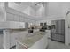Contemporary kitchen featuring white cabinetry, stainless steel appliances, and a central island at 14472 Linden Dr, Spring Hill, FL 34609