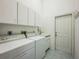 Laundry room with washer, dryer, sink and tile floor at 14472 Linden Dr, Spring Hill, FL 34609