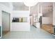 Bright living room with tile floors and white walls leading to an open concept kitchen at 14472 Linden Dr, Spring Hill, FL 34609
