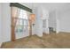 Bright living room featuring travertine floors, large window, and a chandelier at 14472 Linden Dr, Spring Hill, FL 34609