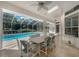 Covered patio with a table, chairs, and a view of the beautiful backyard and sparkling pool at 14472 Linden Dr, Spring Hill, FL 34609