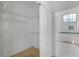 View of the walk-in closet with wire shelving and access to an all-white primary bathroom with a soaking tub at 14472 Linden Dr, Spring Hill, FL 34609