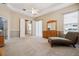 Bright carpeted bedroom with furniture, a ceiling fan, and many windows at 10439 Greendale Dr, Tampa, FL 33626