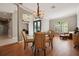 Open-concept dining area features hardwood floors and a stylish chandelier, perfect for entertaining guests at 10439 Greendale Dr, Tampa, FL 33626