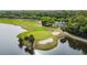 Aerial view of golf course, community building and lake at 10439 Greendale Dr, Tampa, FL 33626