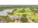 Aerial view of community golf course, lake, and clubhouse at 10439 Greendale Dr, Tampa, FL 33626