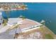 Wide aerial view of house highlighting roof, proximity to waterfront, landscaping, and dock access at 11005 5Th E St, Treasure Island, FL 33706