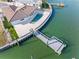 Aerial view of the property highlighting backyard pool, private dock, and surrounding waterfront landscape at 11005 5Th E St, Treasure Island, FL 33706