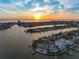 Panoramic aerial view of waterfront homes, canals, and a stunning sunset over the ocean at 11005 5Th E St, Treasure Island, FL 33706