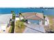 Home with a two-car garage, well-kept lawn, offering serene waterfront views at 11005 5Th E St, Treasure Island, FL 33706