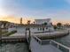 Exterior of waterfront home featuring a private dock and pool, offering luxurious waterfront living at 11005 5Th E St, Treasure Island, FL 33706