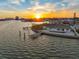 Sunset view of waterfront home with private dock and pool, offering serene living at 11005 5Th E St, Treasure Island, FL 33706
