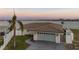 Charming single-story home with a two-car garage, well-maintained lawn, and waterfront views at 11005 5Th E St, Treasure Island, FL 33706