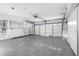 Bright garage features overhead storage and a white paneled garage door with windows to allow for plenty of natural light at 11005 5Th E St, Treasure Island, FL 33706