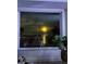 A view of the moon and city lights at night from a large window at 11005 5Th E St, Treasure Island, FL 33706